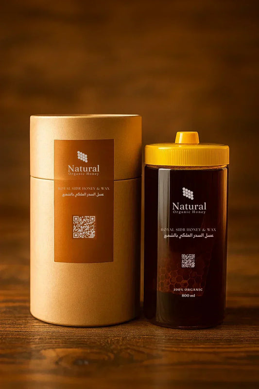 800ml jar of Natural Organic Royal Sidr Honey with yellow lid next to kraft paper packaging on wooden surface