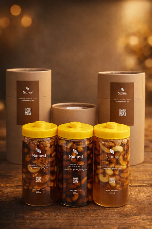 Luxury package of organic honey with nuts, featuring Natural Organic Honey jars on a wooden table.