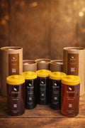 Natural Organic Honey assorted jars with yellow lids, product packaging on rustic wood table