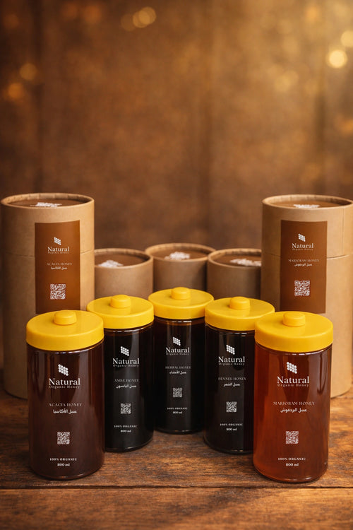 Natural Organic Honey assorted jars with yellow lids, product packaging on rustic wood table