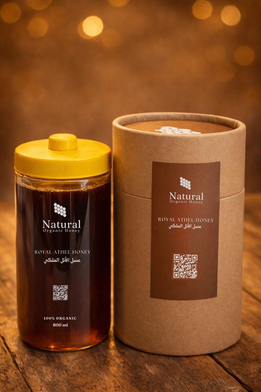 Natural organic Royal Athel honey in clear bottle with yellow lid and brown packaging on wood