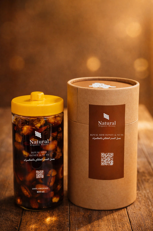 Natural Organic Honey Royal Sidr honey with nuts in a jar and premium packaging on wood